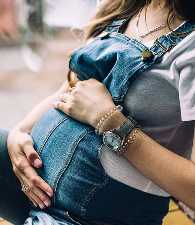 Pregnant woman in overalls