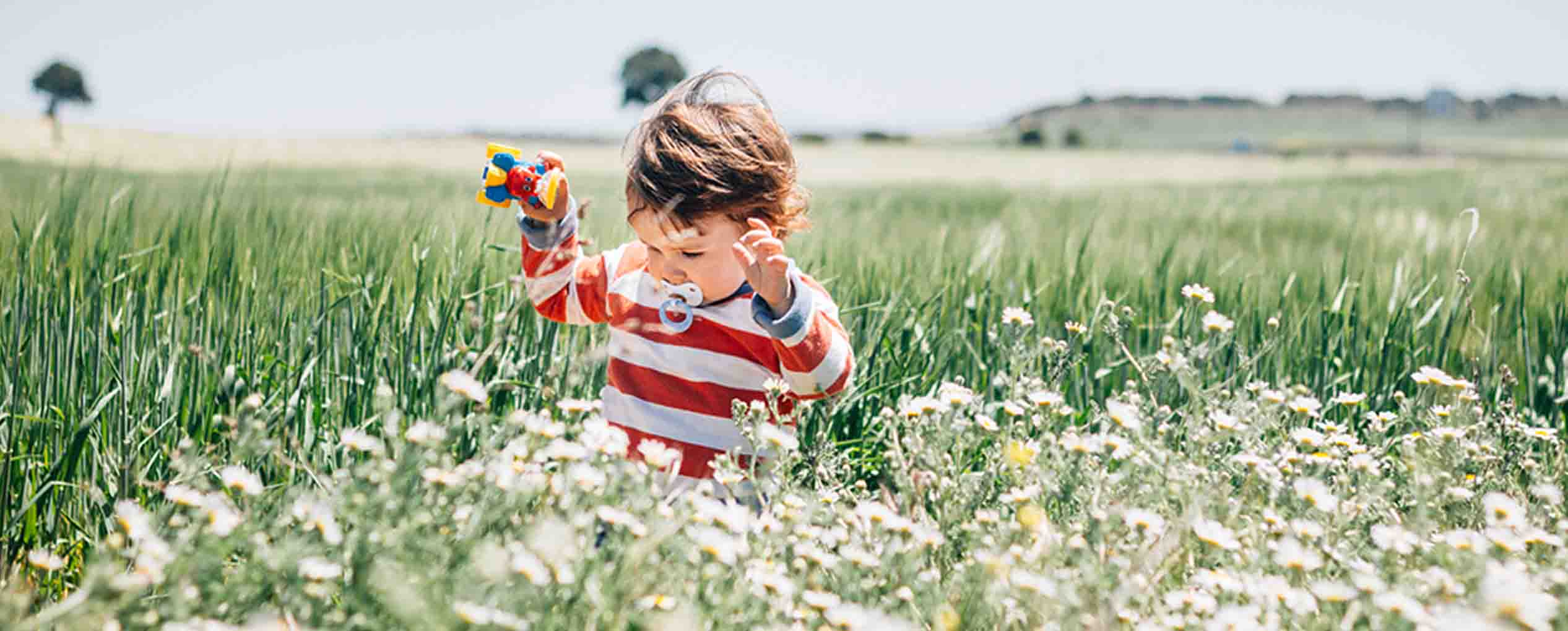 Little boy running through the grass