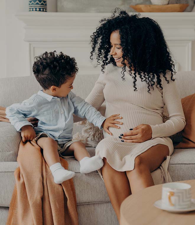 Mom and child admiring baby bump