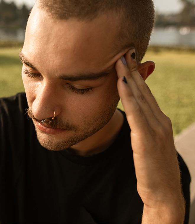 Young man holding his head in pain