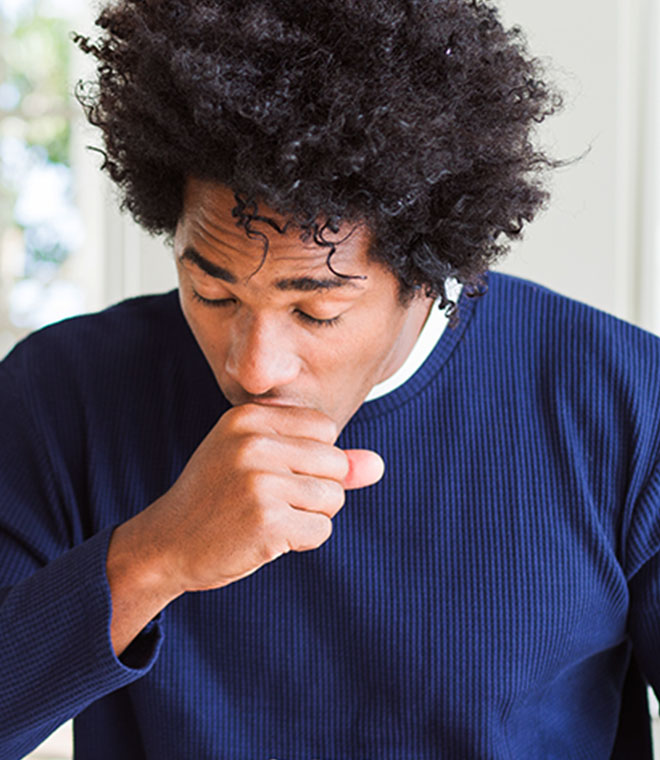 Black man coughing into his hand