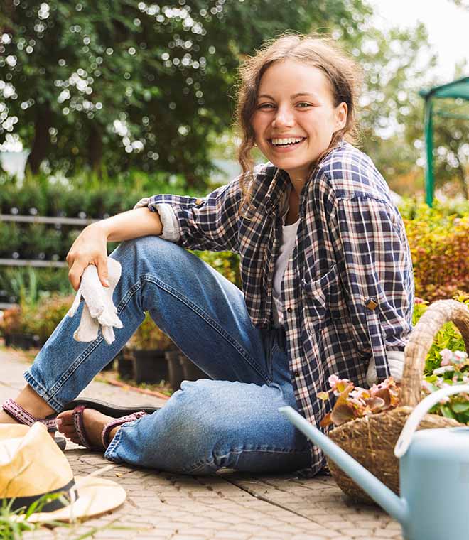 Young woman smiling in her garden