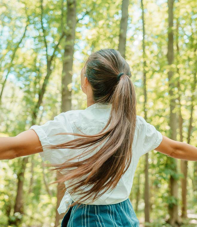 Girl with long hair in the woods