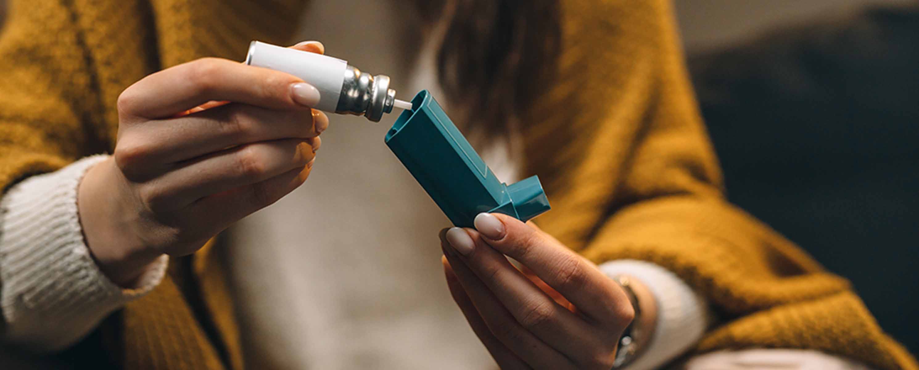 Woman putting together an inhaler