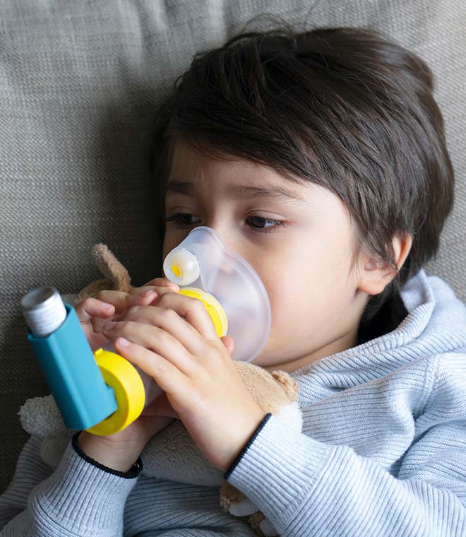 Young boy using an inhaler