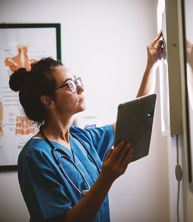 Young female doctor looking at xray