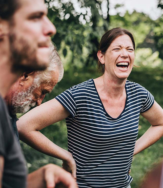 Woman and two men laughing