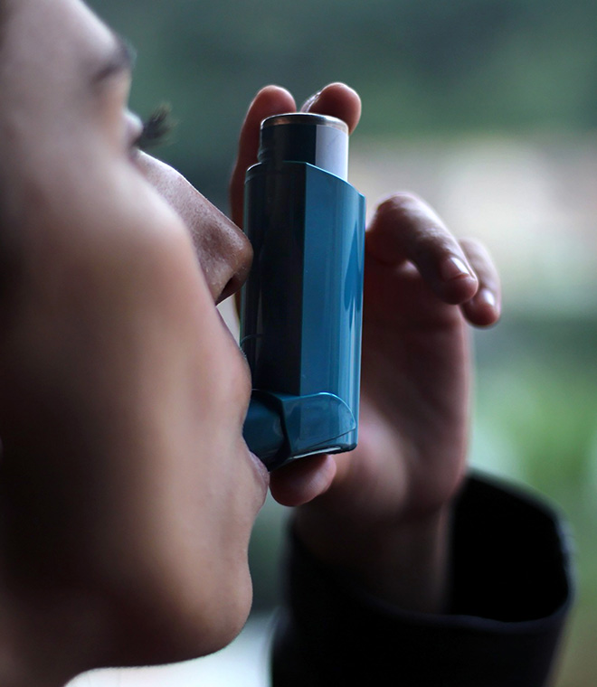 Woman using an inhaler