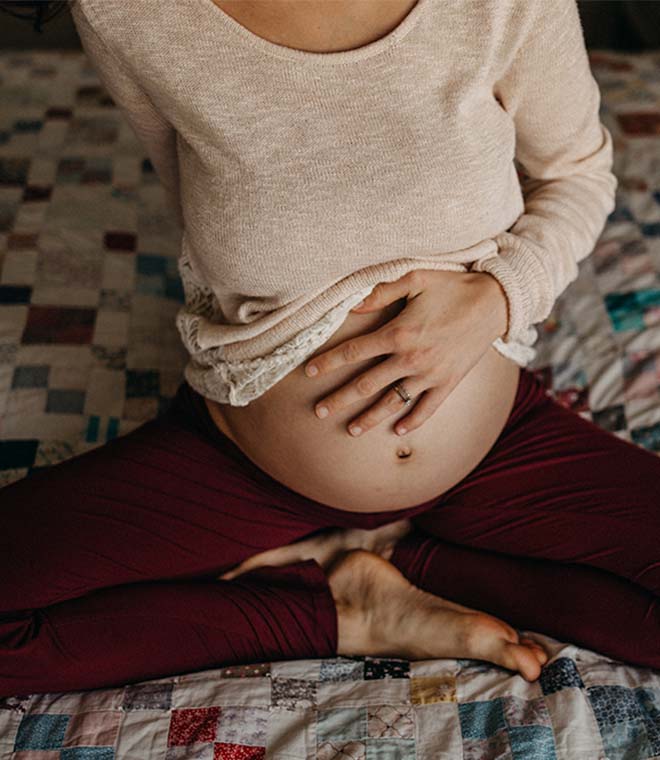 Pregnant woman holding her belly