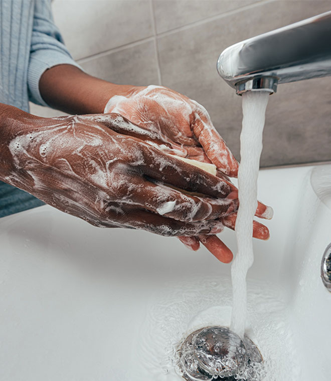 Black woman washing her hands