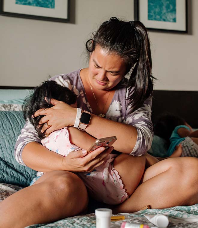 Woman holding sick child