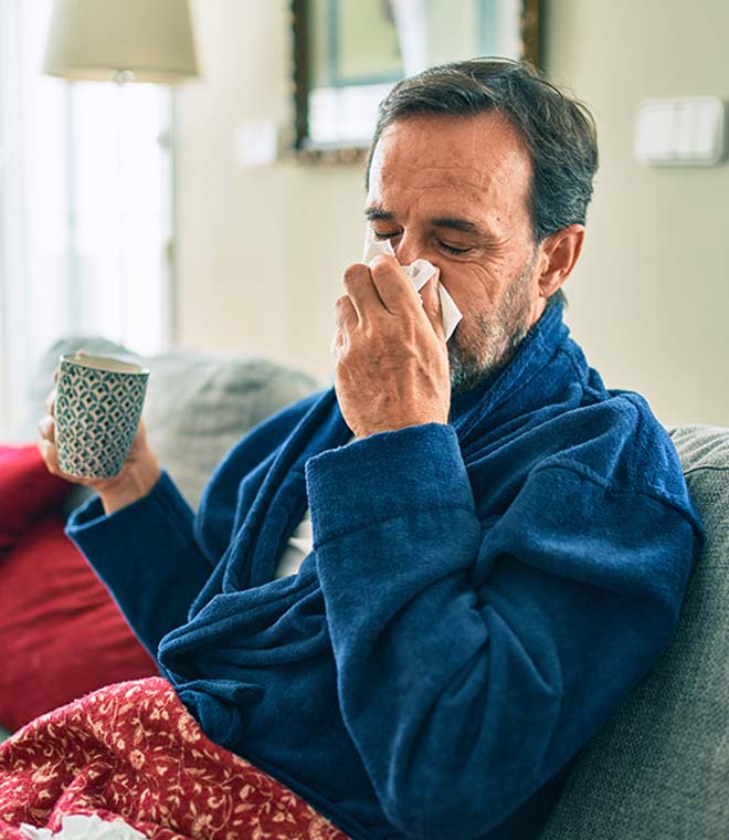 Older white man blowing his nose