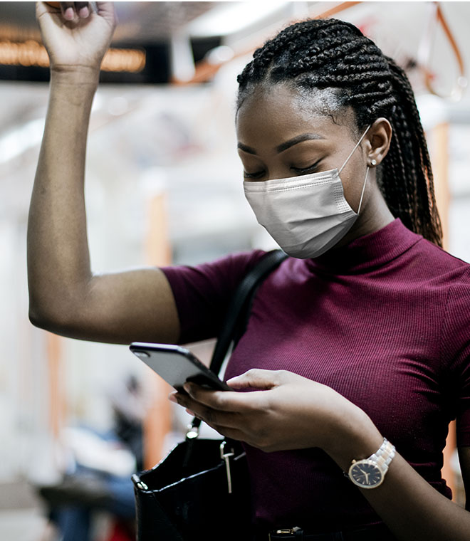 Young black woman wearing a mask on public transportation