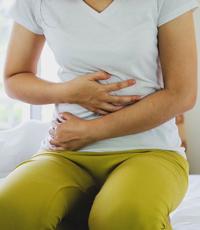 Woman holding her stomach in pain