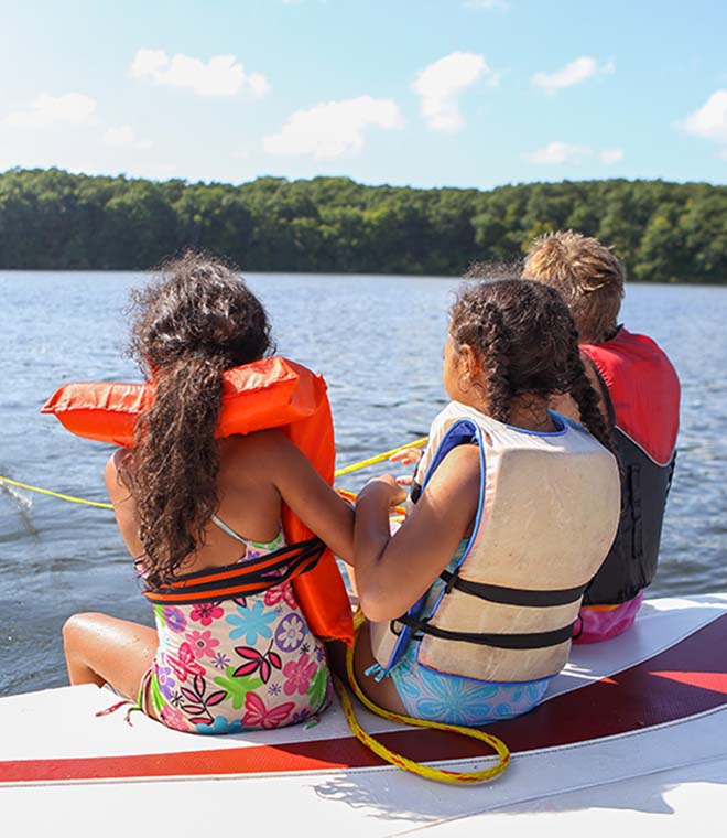 Two young girls and young boy on boat