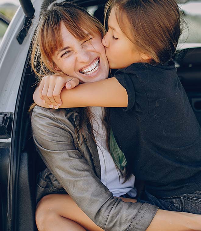 Young white woman holding white girl