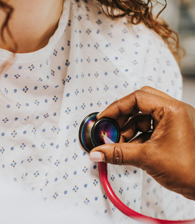 Doctor listening to a girl's heart