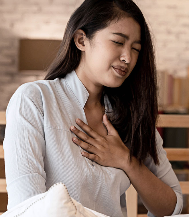 Young Asian woman grabbing her chest