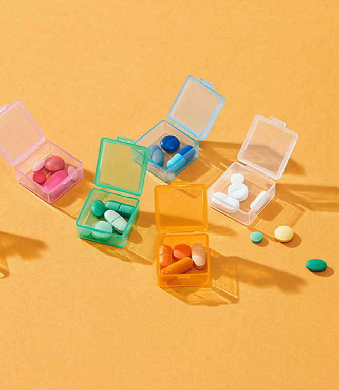 Colorful pills on a yellow background