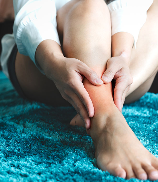 Woman grabbing her ankle