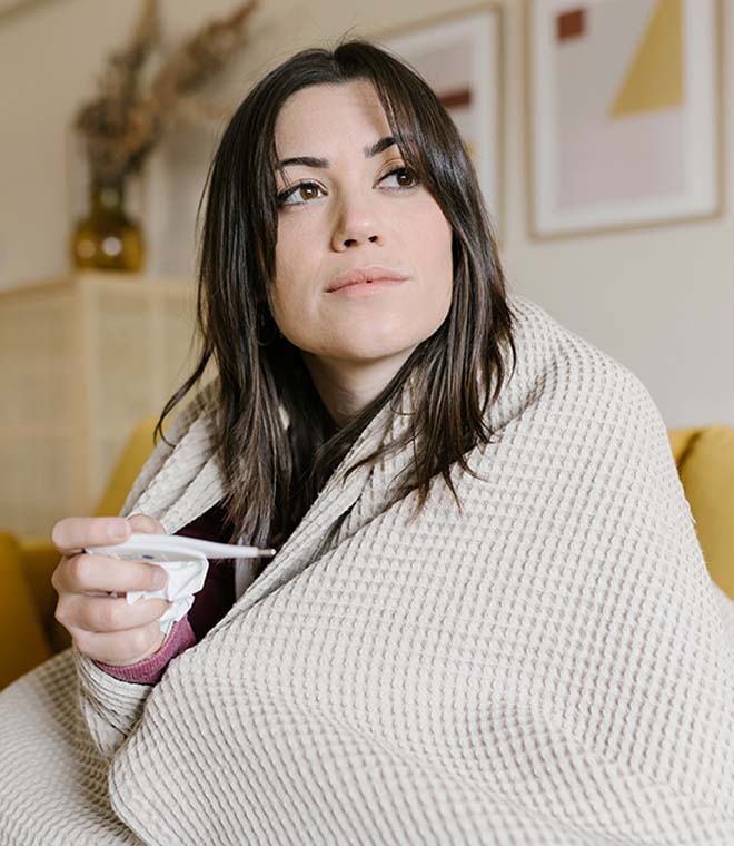 Young white woman wrapped up in a blanket