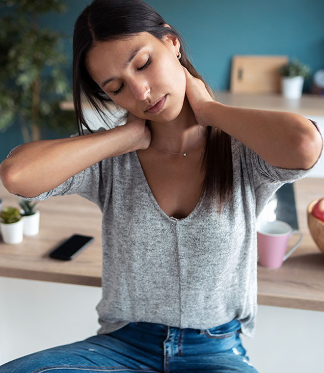 Young brunette woman holding her neck in pain