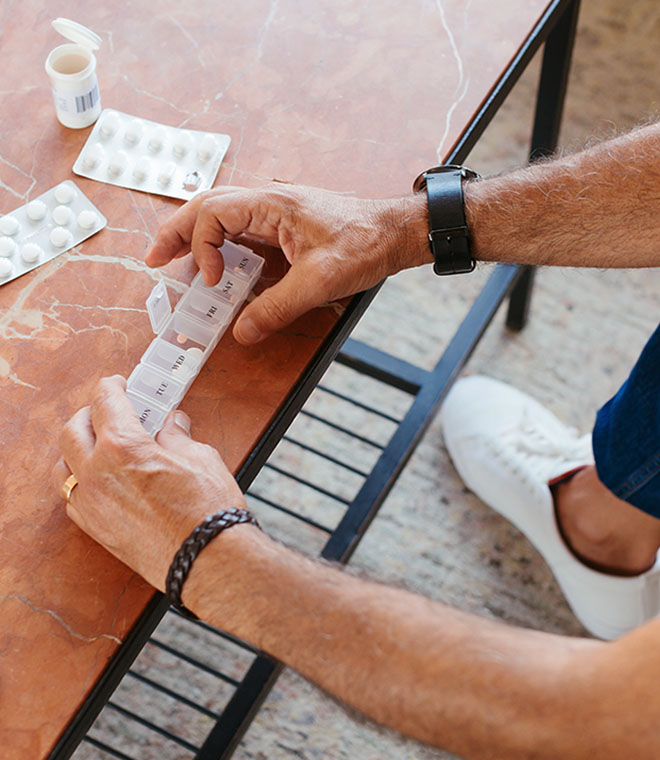 Man opening a pill box