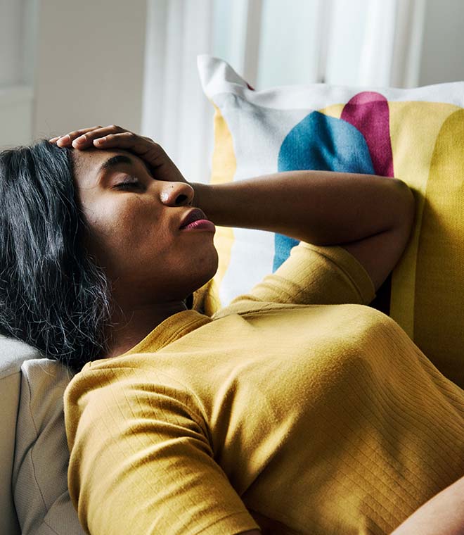 Young black woman holding her head