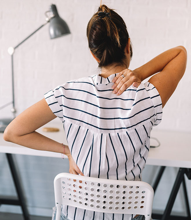 Younger woman holding her neck and back