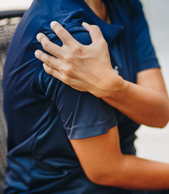 Man grabbing his shoulder