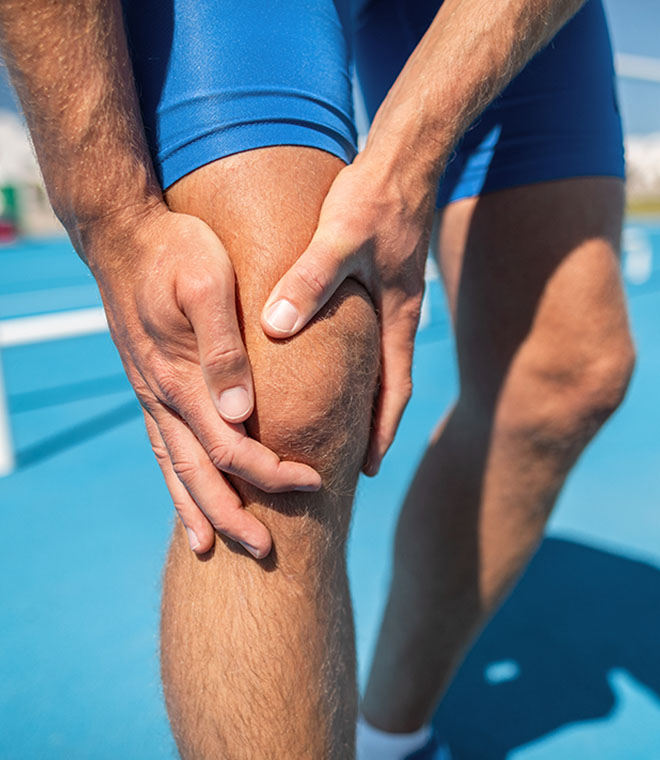 Man holding knee