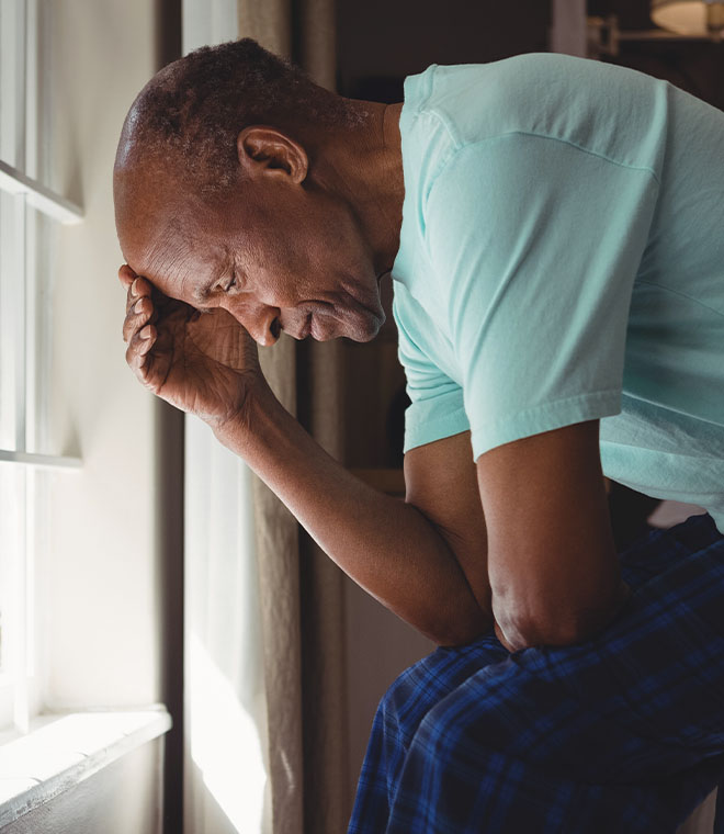 Black man with his head down