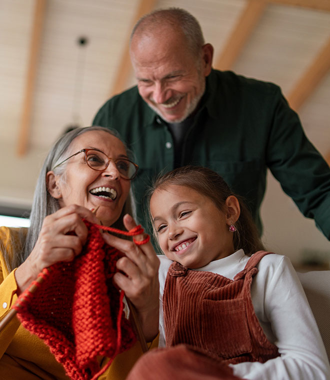 Grandparents knitting with their granddaughter