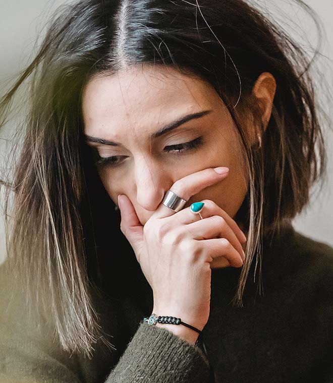 Millennial woman covering her mouth
