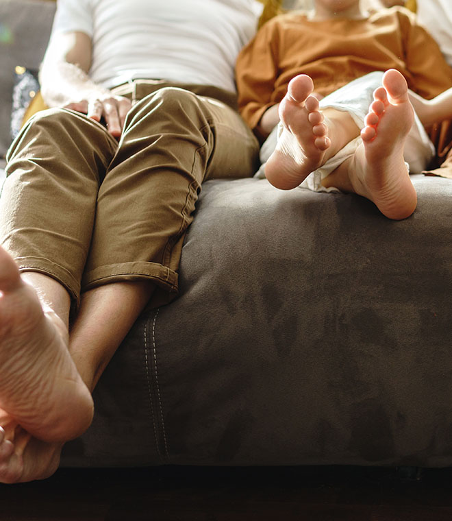 Parent and kids feet on the couch