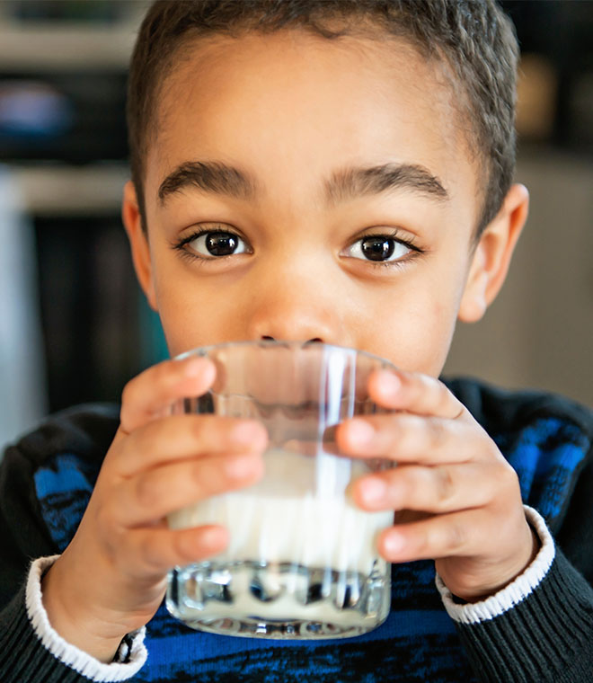 Little boy drinking a glass of milk