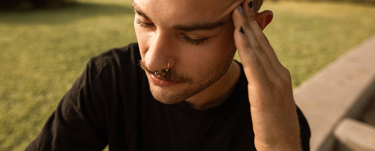 Young man holding his head in pain