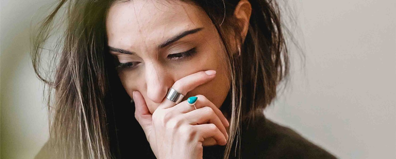 Millennial woman covering her mouth