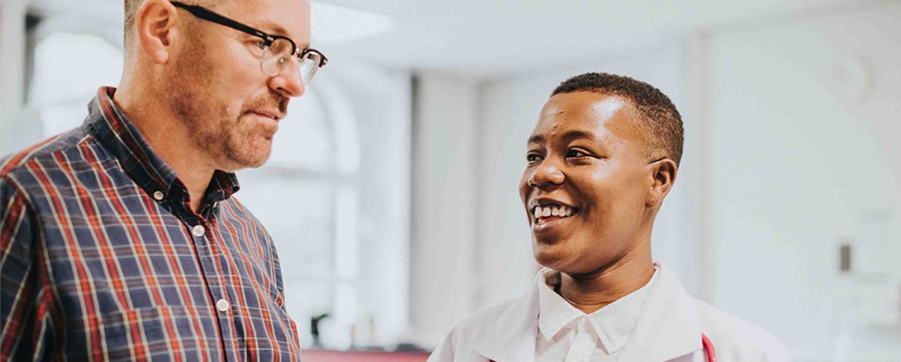 Cheerful physician giving a patient news